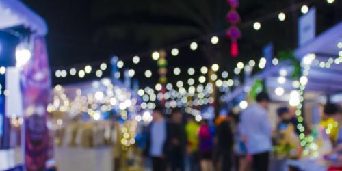 Festive atmosphere and illuminated stalls at a night market in a village in the Gorges du Tarn.